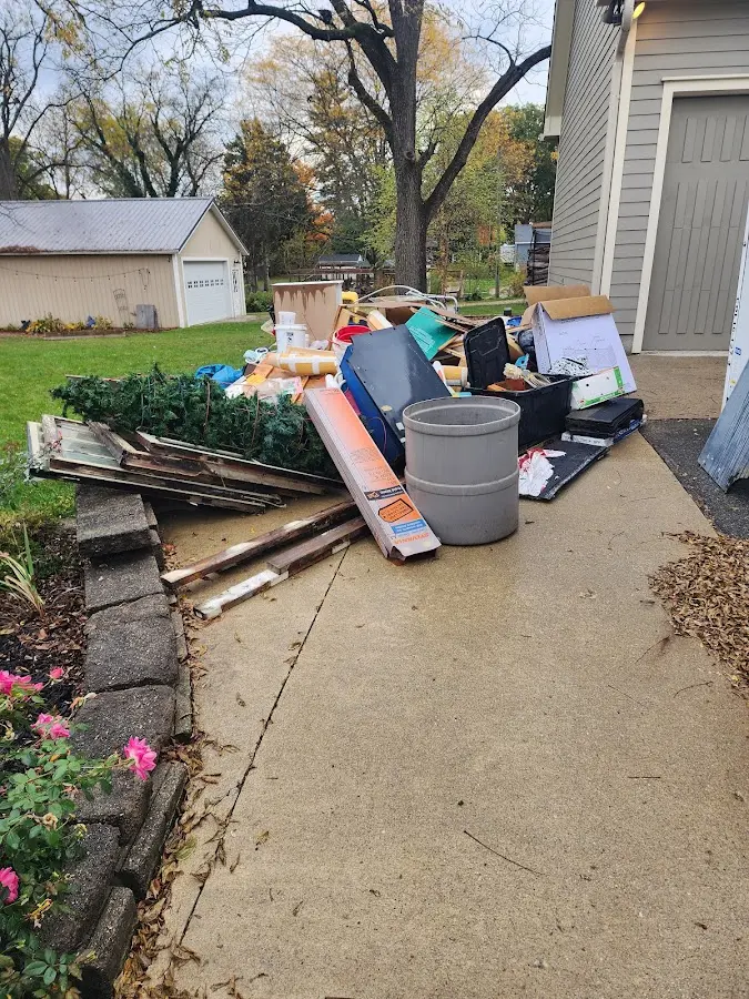 Dumpster being loaded with debris for Roofing Dumpster Rental in Alpine